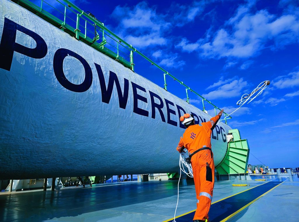 A crew member standing next to an LPG deck tank